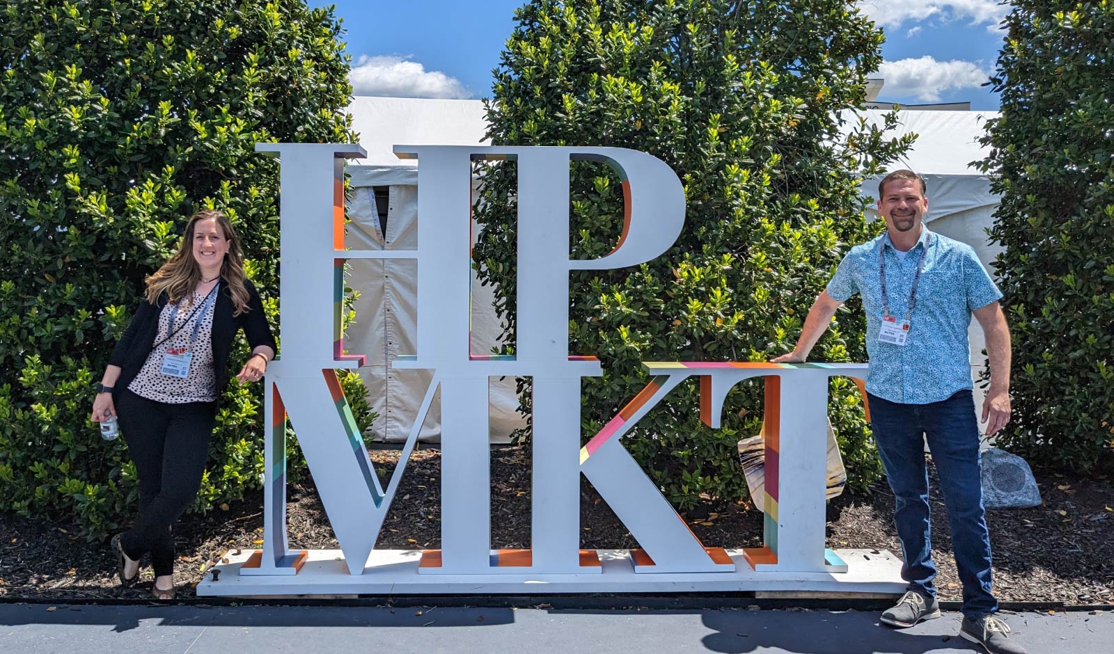 Store owners Colleen and Lao standing by the High Point Market sign