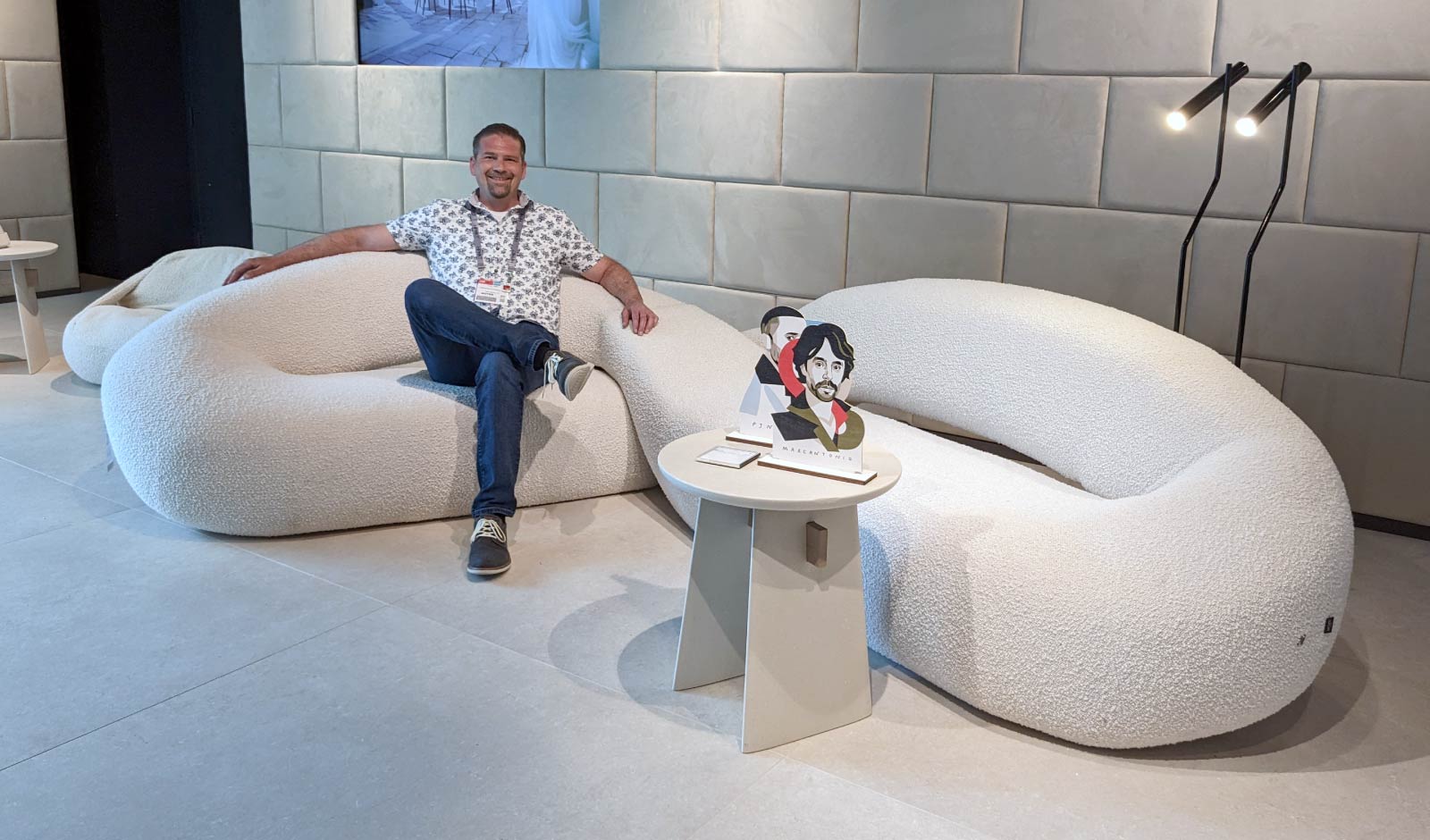 Store owner Lao Triffin sits on a contemporary white Italian sectional