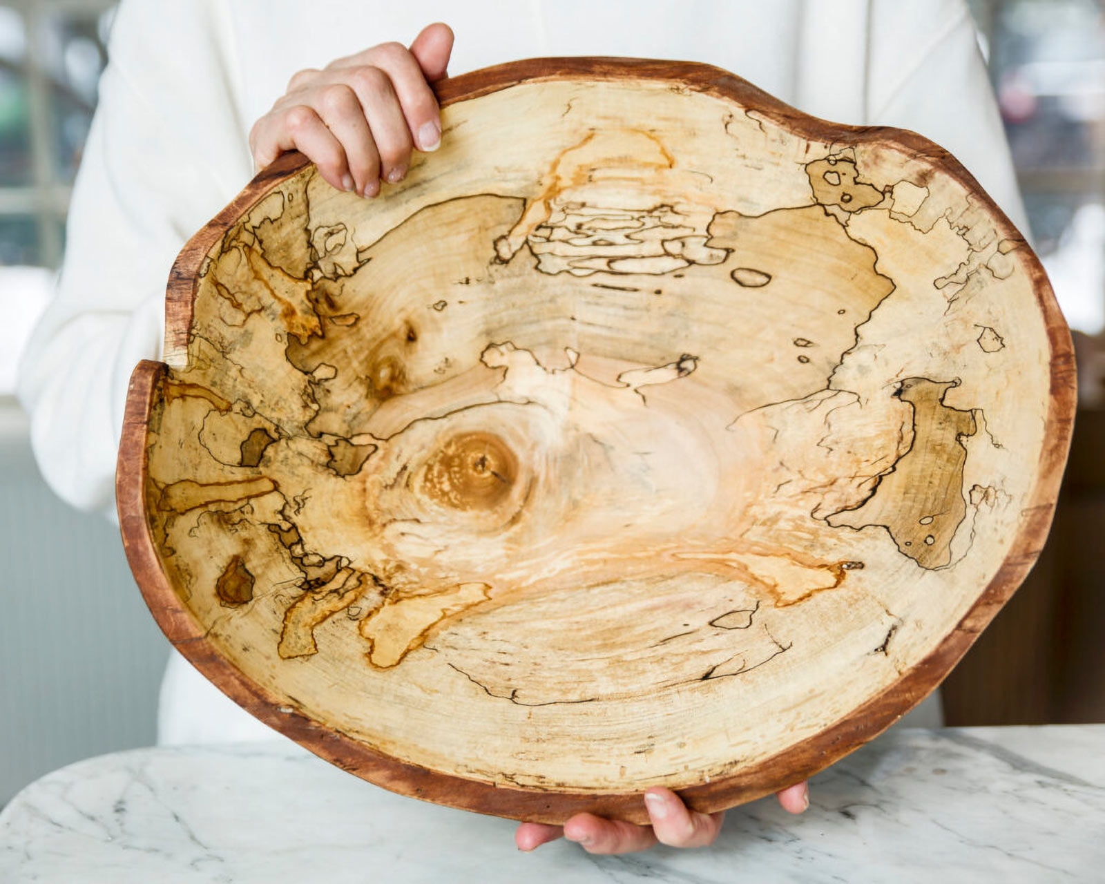 A live edge spalted maple bowl, made by Spencer Peterman